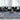 Blue large Oushak rug in a modern design living room with contemporary black furniture