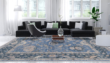 Blue large Oushak rug in a modern design living room with contemporary black furniture