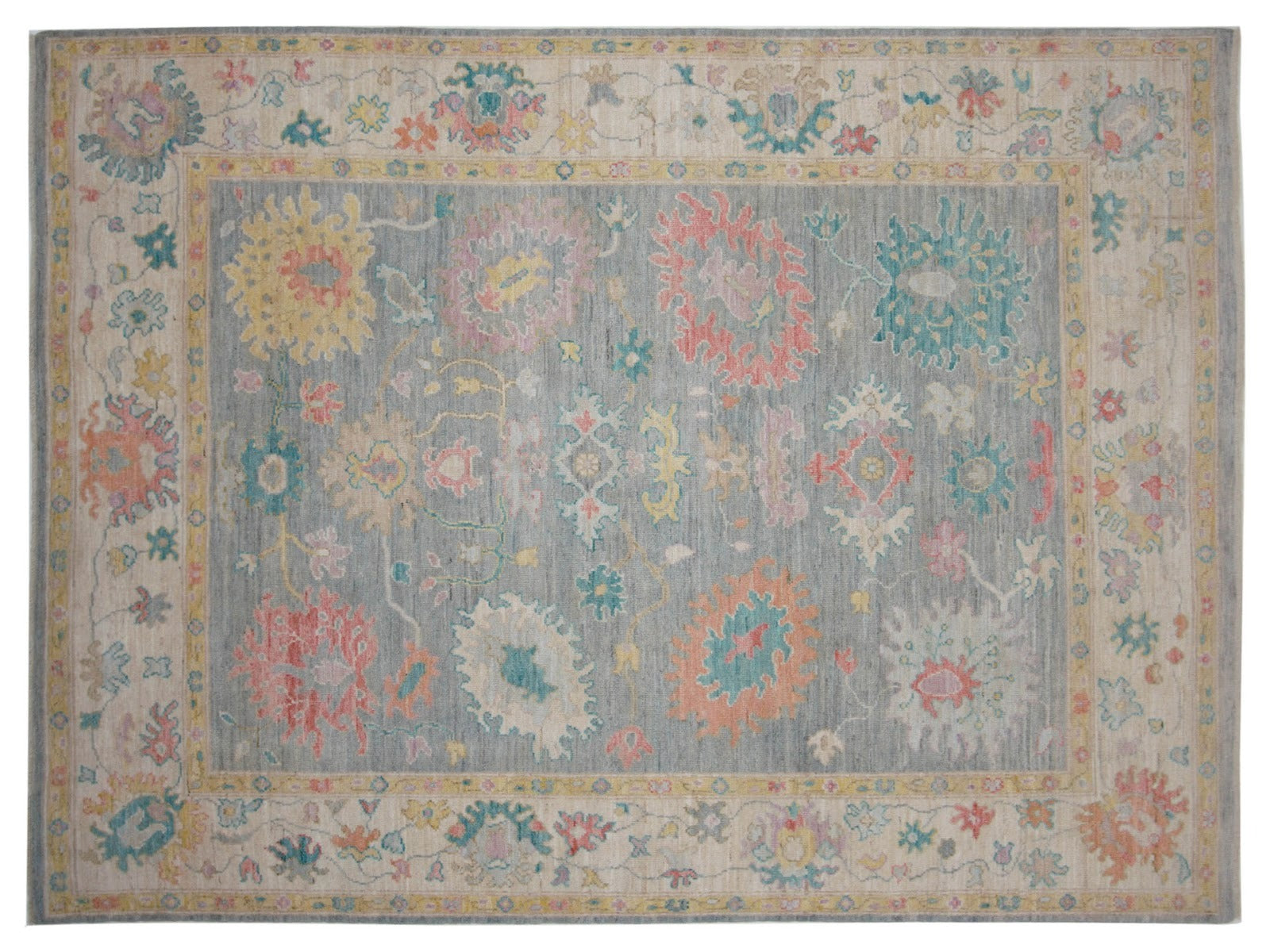 8x10 Turkish rug in transitional design featuring a gray backdrop with orange, blue, and pink floral motifs, framed by an ivory border, hand-knotted in 100% wool