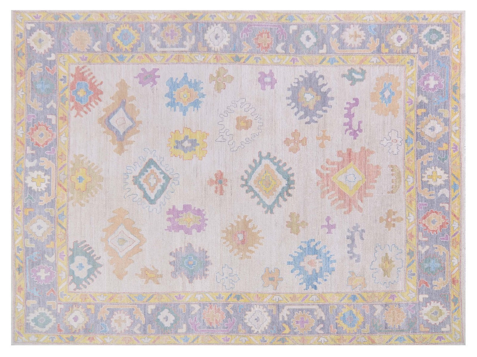 9x12 Faberge rug in transitional design with blues, yellows, oranges, and purples, framed by a grayish-blue border, hand-knotted in 100% wool